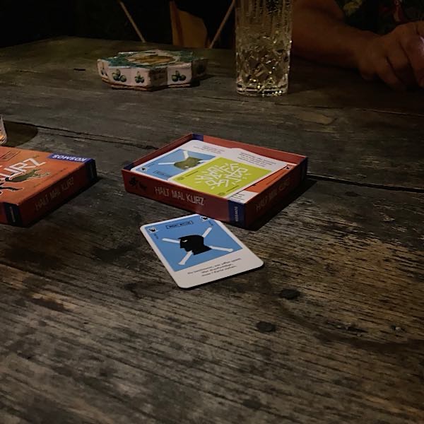 12-von-12-kartenspielen Kartenspiel liegt auf Holztisch auf der Terasse.